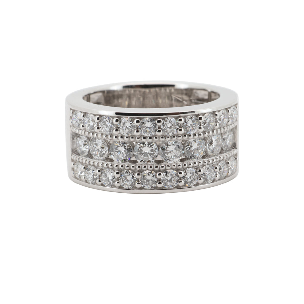 Platinum ring with multiple rows of diamonds on a white background