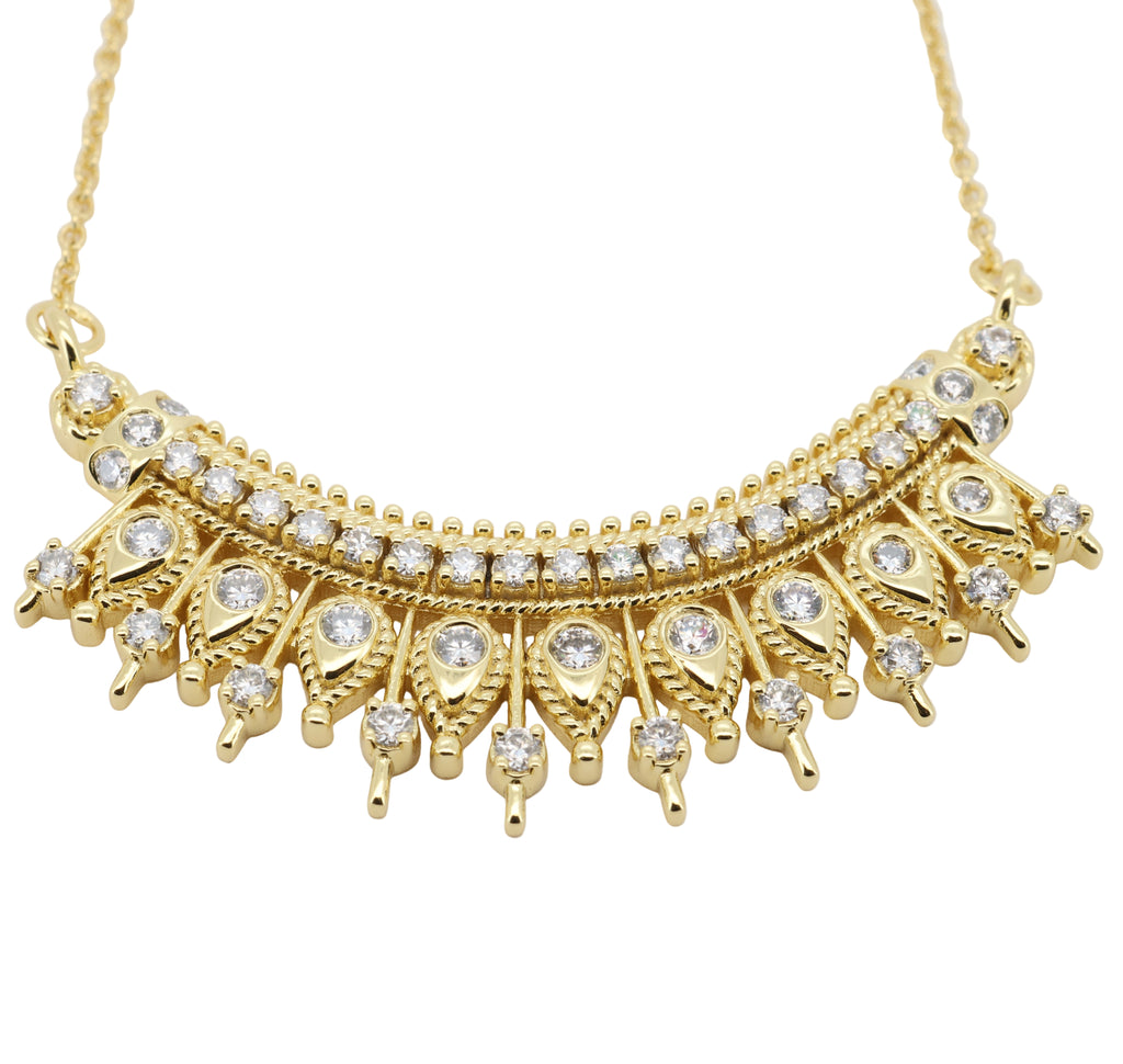 Gold necklace with diamonds on a light gray background